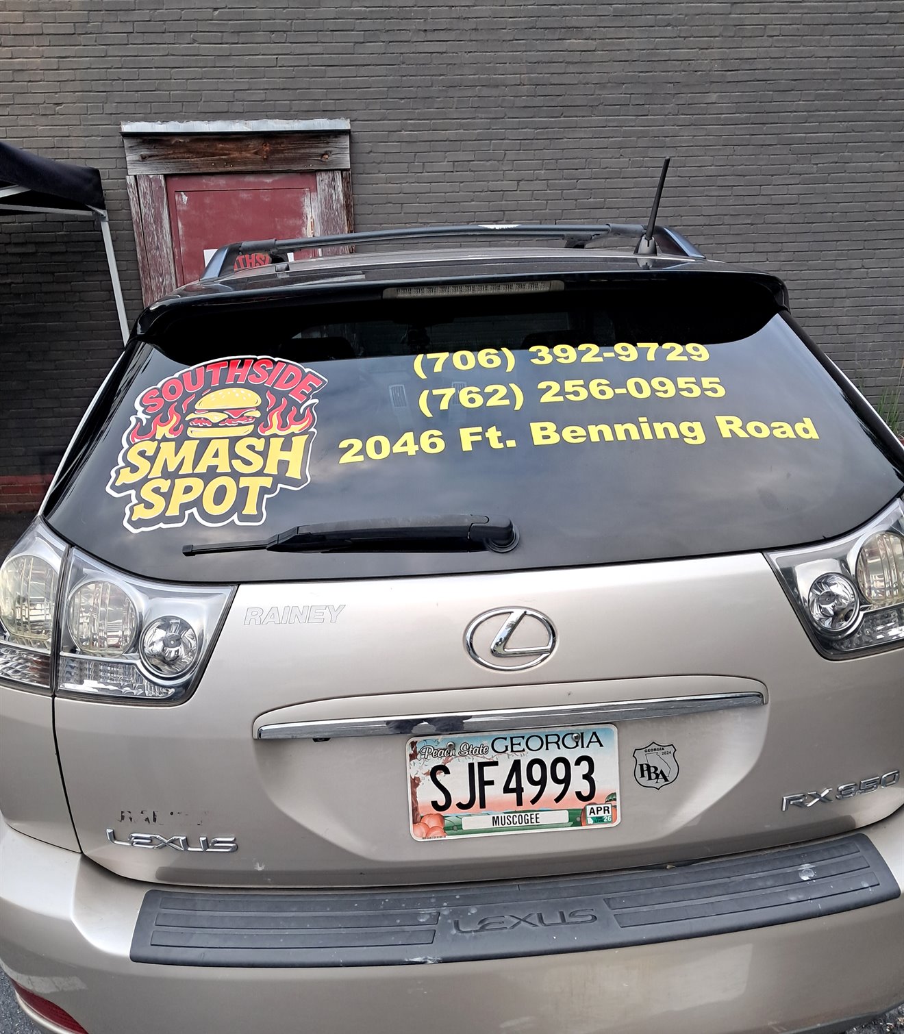 Southside Smash Spot logo, phone numbers, and address installed on a vehicle rear window